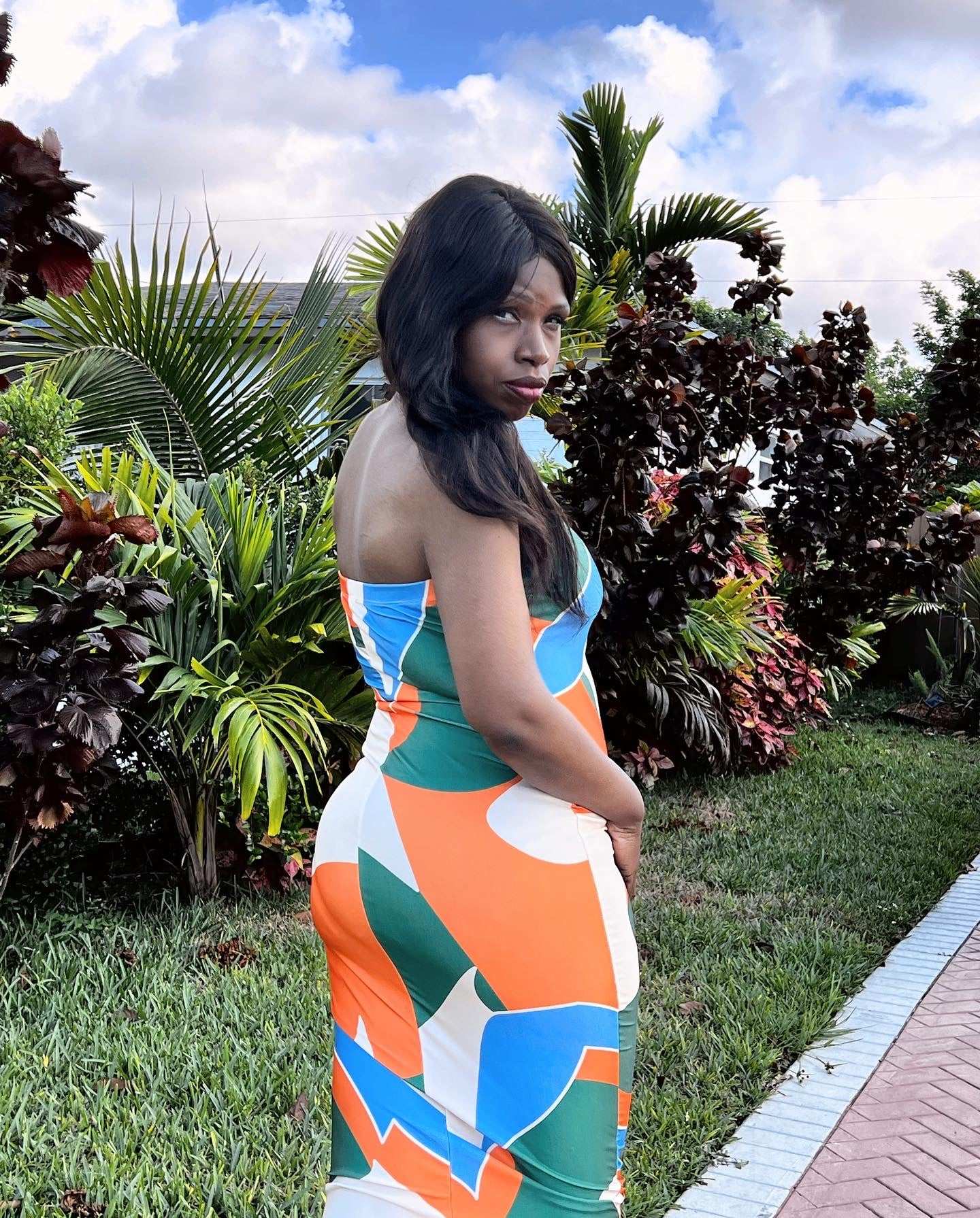 Fun, Flirty, and Sexy! This colorful fitted dress hugs all your curves in the right places. With bold colors of orange, green, and blue—this look is simple, yet elegant at the same time. A perfect dress for a date night with hubby or a night out with the girls!